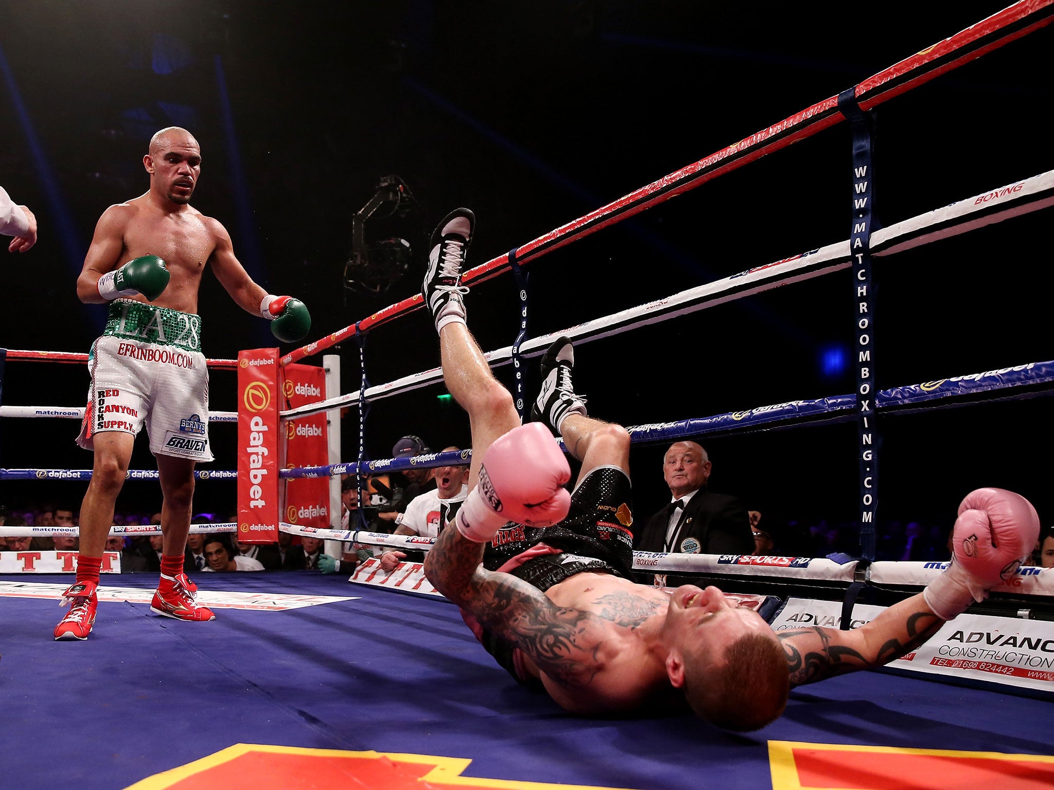 Ricky Burns is floored by Ray Beltran in the eighth round in Glasgow