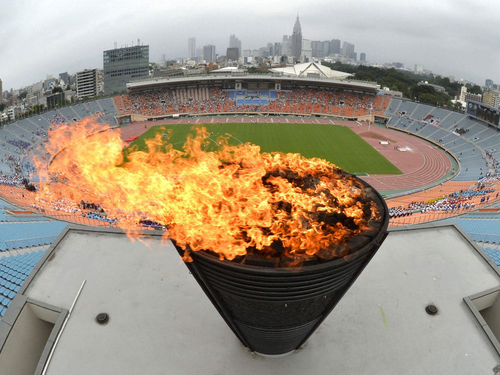 A flame on the Olympic cauldron, which was used at the 1964 Games in Tokyo, is relit in celebration