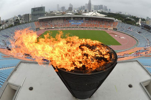 A flame on the Olympic cauldron, which was used at the 1964 Games in Tokyo, is relit in celebration