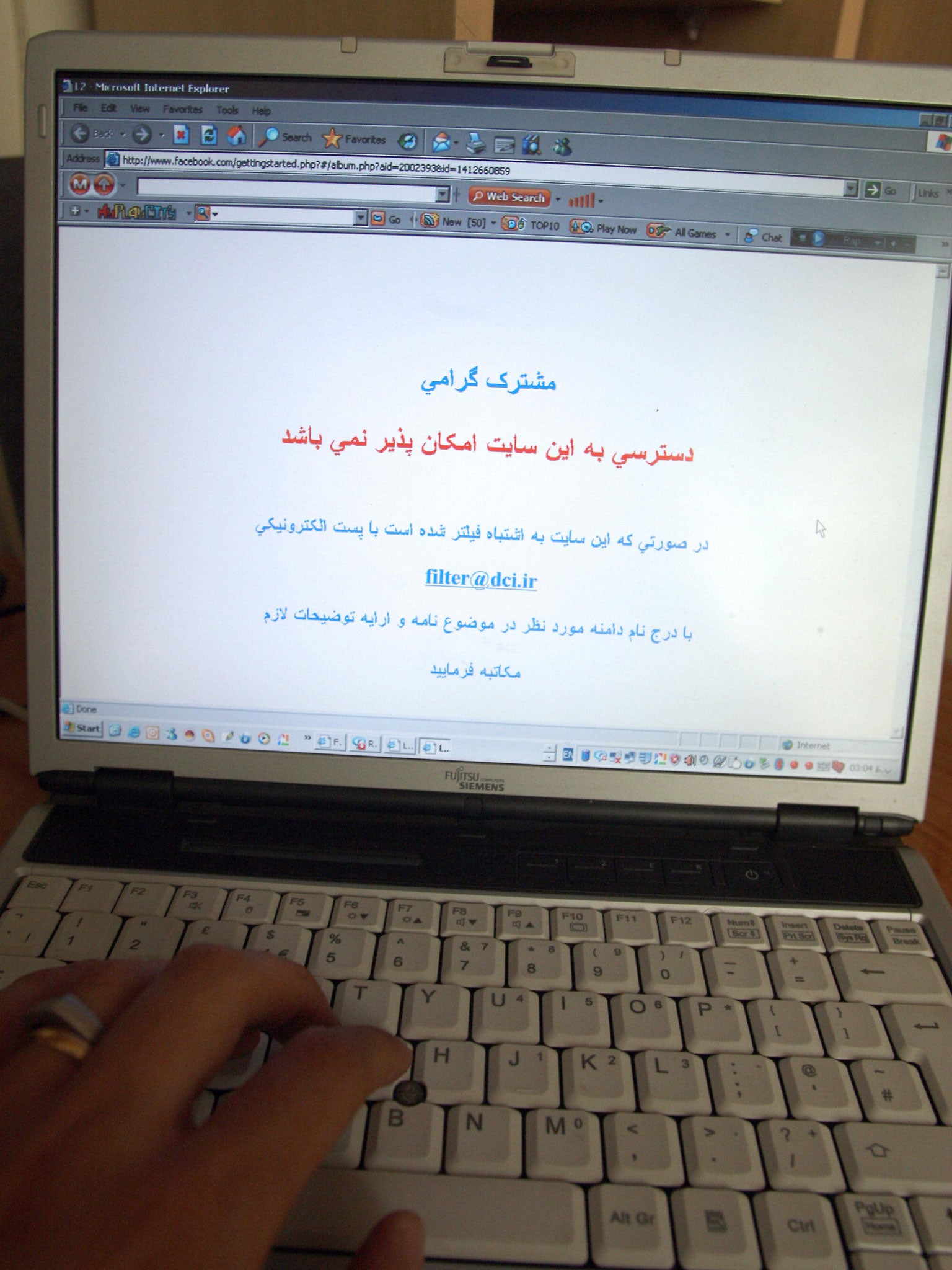 File: An Internet user tries to log onto Facebook in Tehran. A message in Farsi reads "Dear subscriber, access to this site is not possible...."