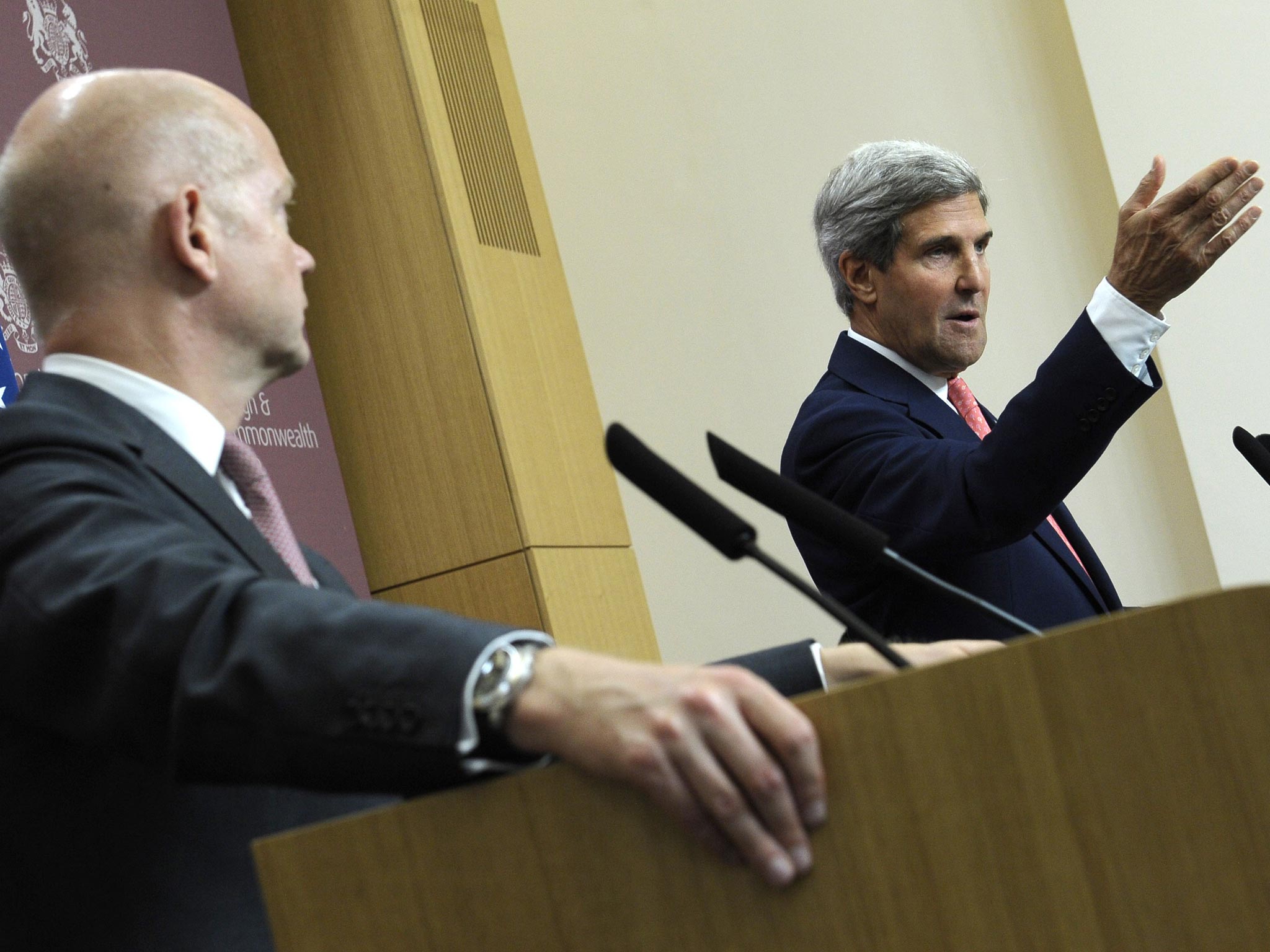US Secretary of State John Kerry, right, speaks as Britain's Foreign Minister William Hague, left, listens during a news conference at the Foreign and Commonwealth Office in London