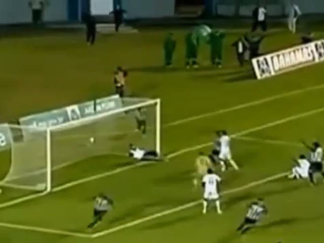 A Brazilian football team masseur runs onto the pitch to save a last-minute shot in a semi-final playoff