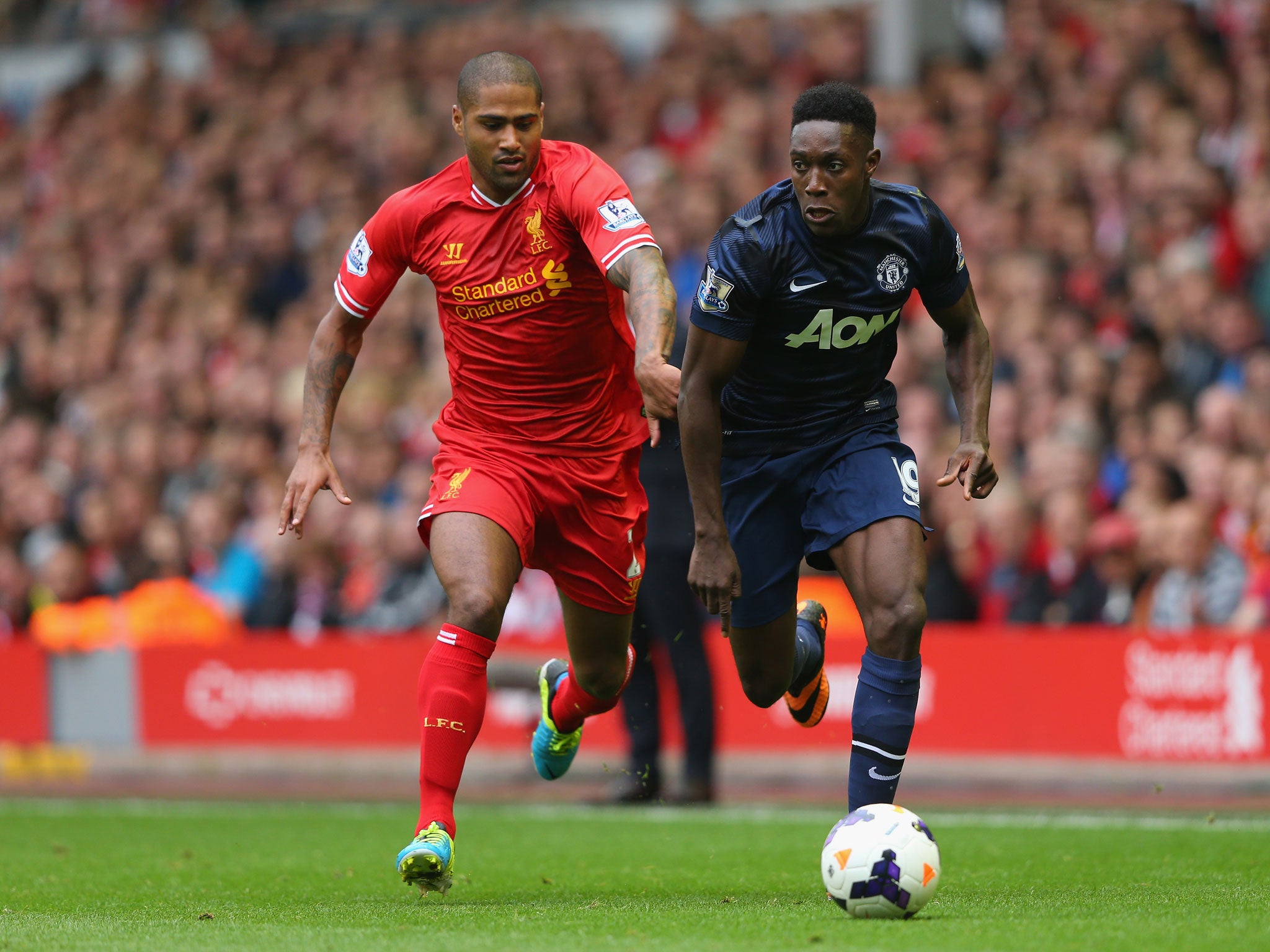 Glen Johnson of Liverpool challenges Manchester United's Danny Welbeck