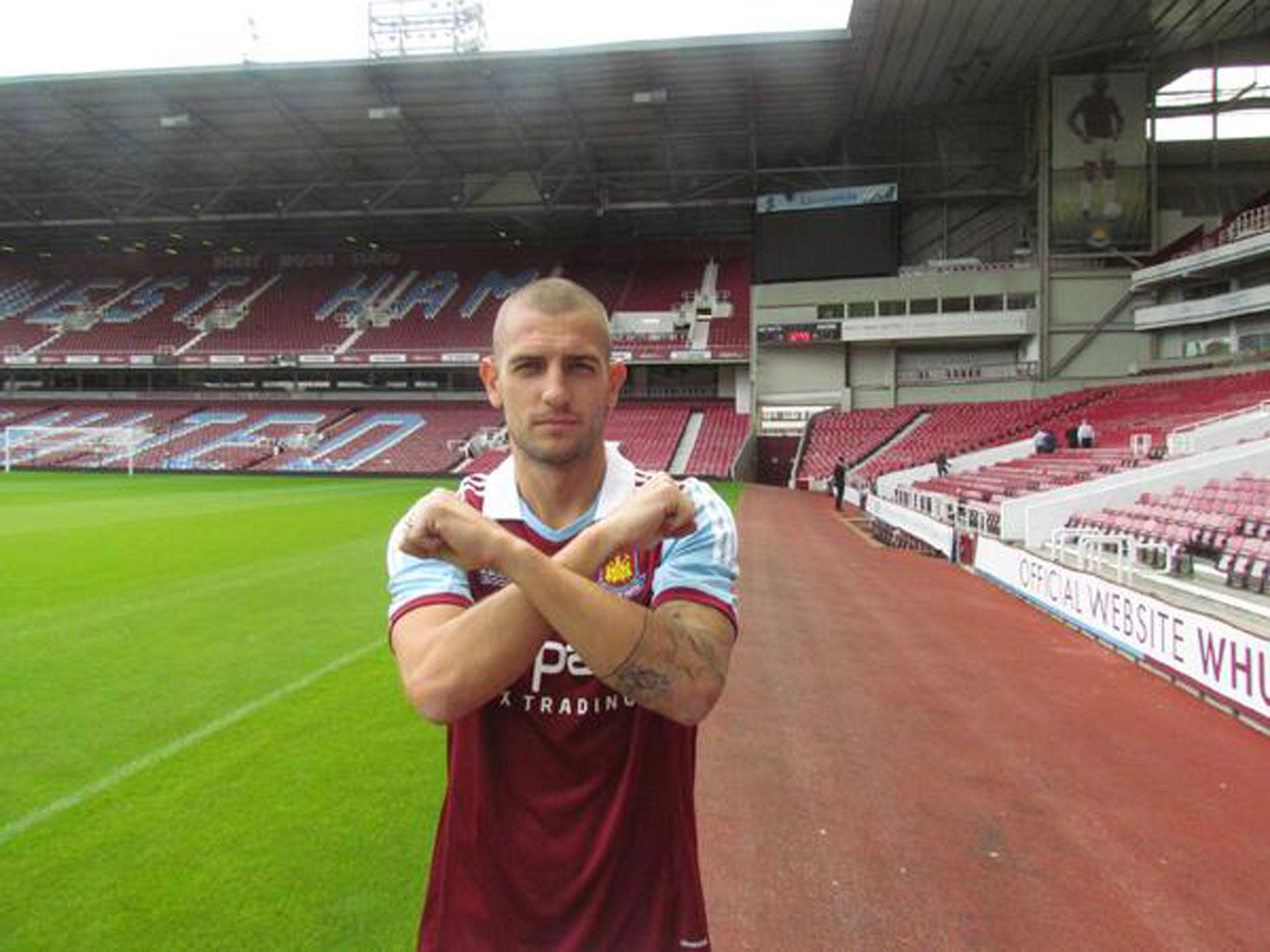 Mladen Petric poses in a West Ham shirt after completing his move to the Hammers