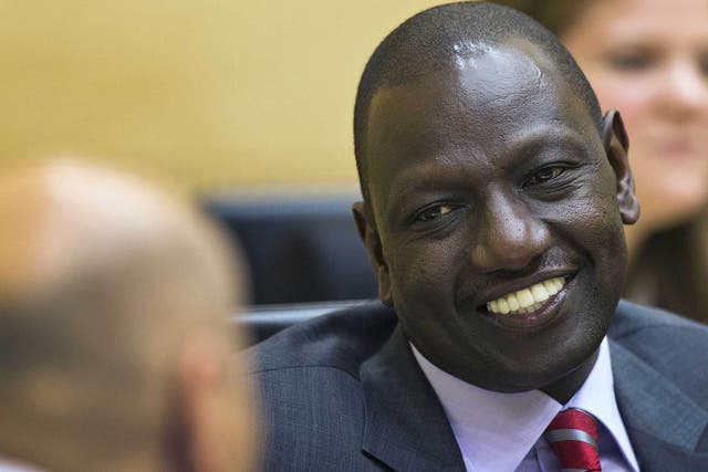 Kenya's Deputy President William Ruto speaks with his defence counsel