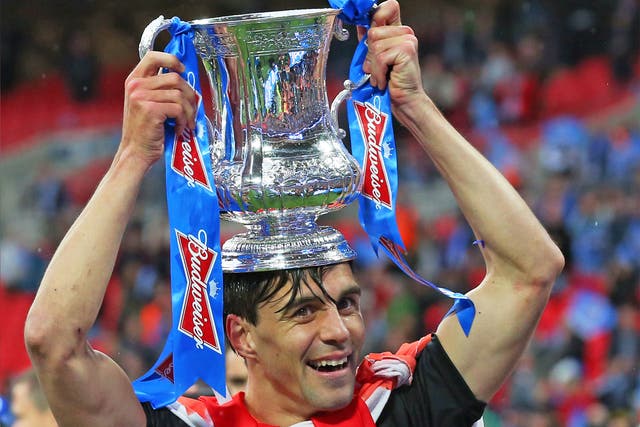 Paul Scharner of Wigan Athletic celebrates winning the FA Cup, sponsored by Budweiser, after a 1-0 win over Manchester City at Wembley in May