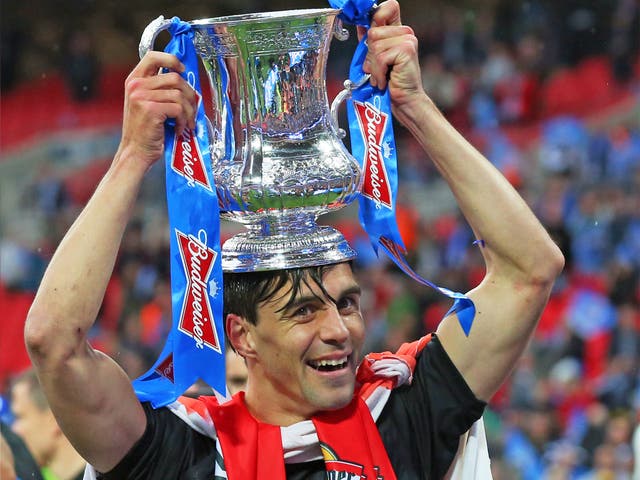 Paul Scharner of Wigan Athletic celebrates winning the FA Cup, sponsored by Budweiser, after a 1-0 win over Manchester City at Wembley in May