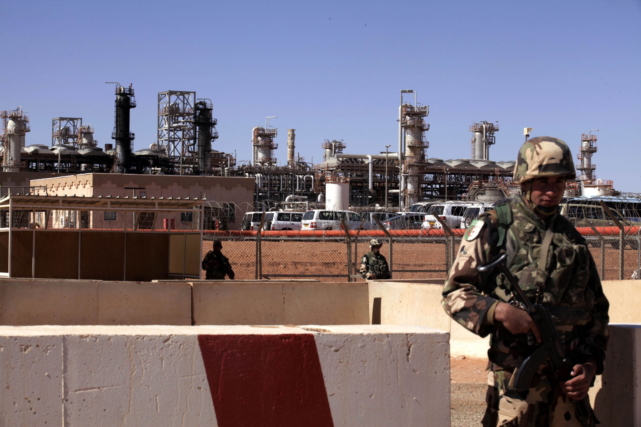 Algerian soldiers stand guard at the In Amenas gas plant facility in In Amenas, Tiguentourine, eastern Algeria on January 31, 2013, as the Algerian government opened the site of the Algeria's hostage crisis to the media for the first time. The Islamist militants attacked the facility on January 16 and 37 foreign workers were killed in the terror attack.