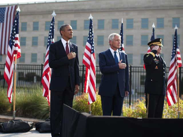 From left to right: U.S. President Barack Obama, U.S. Defense Secretary Chuck Hagel and Chairman of the Joint Chiefs of Staff Martin Dempsey stand during a ceremony in observance of the terrorist attacks of 9/11 at the Pentagon
