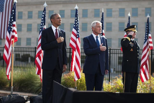 From left to right: U.S. President Barack Obama, U.S. Defense Secretary Chuck Hagel and Chairman of the Joint Chiefs of Staff Martin Dempsey stand during a ceremony in observance of the terrorist attacks of 9/11 at the Pentagon