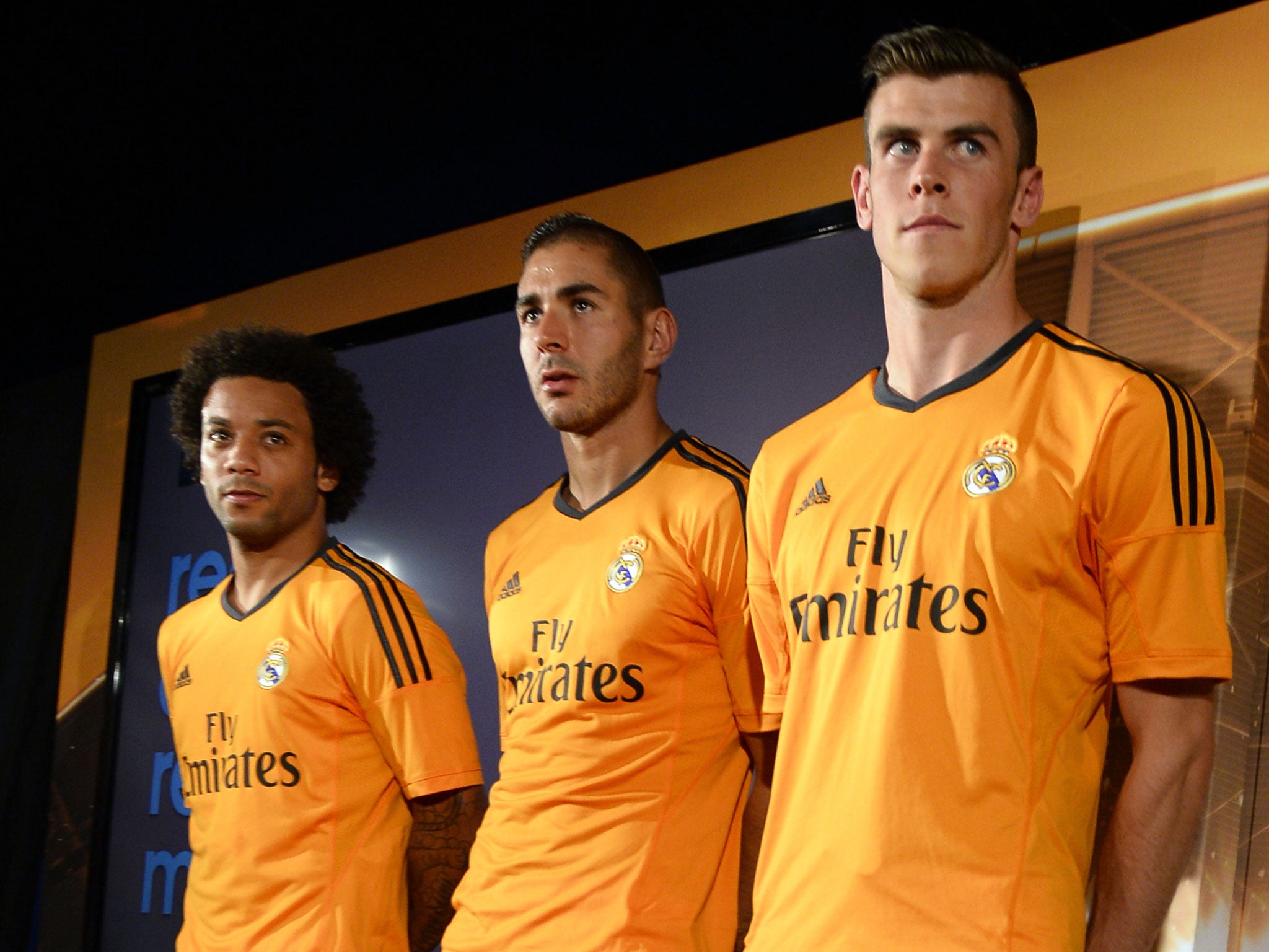 Gareth Bale (far right) unveils Real Madrid's new third shirt alongside Marcelo (left) and Karim Benzema (centre)