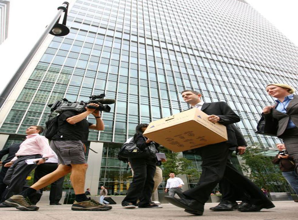 A man carries a box after leaving the Lehman Brothers European Headquarters building in Canary Wharf in 2008