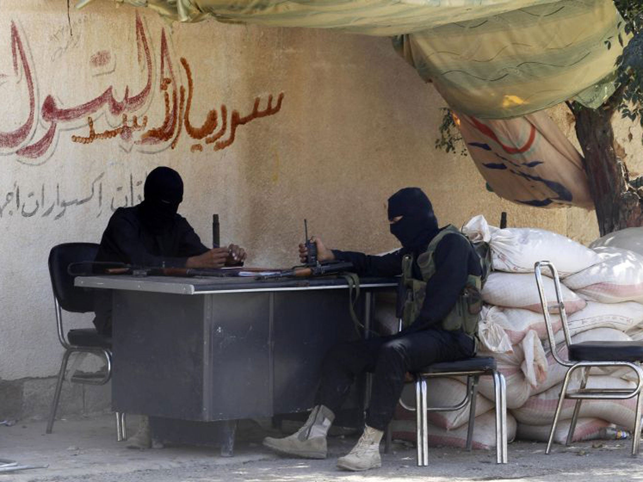 Free Syrian Army fighters sit at their guard post