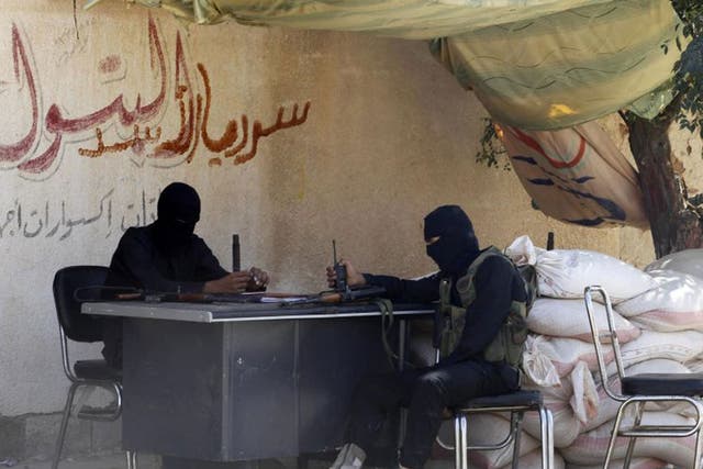Free Syrian Army fighters sit at their guard post