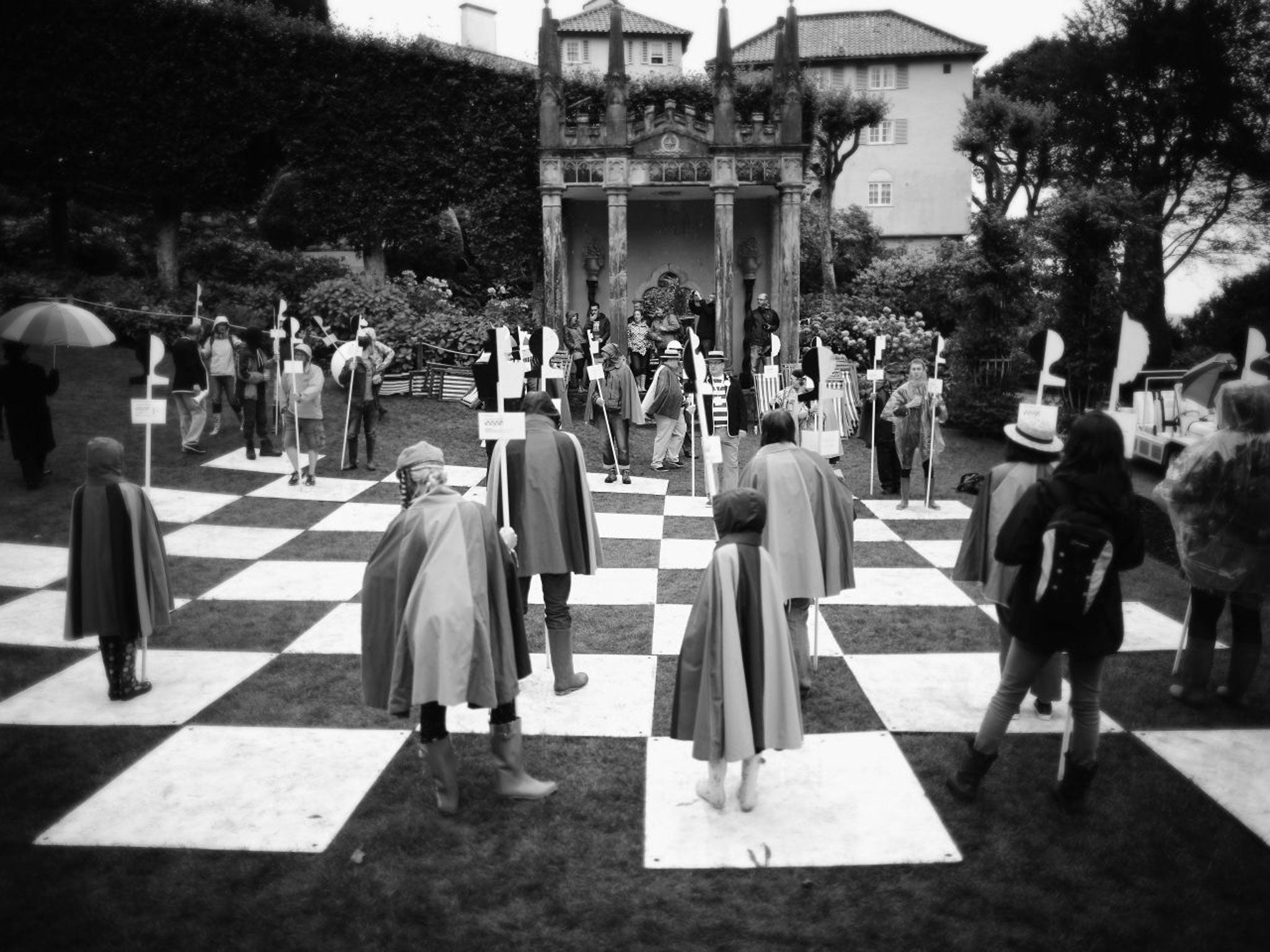 Festival-goers play on the human chess board from the cult TV series The Prisoner