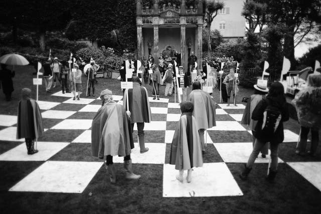 Festival-goers play on the human chess board from the cult TV series The Prisoner