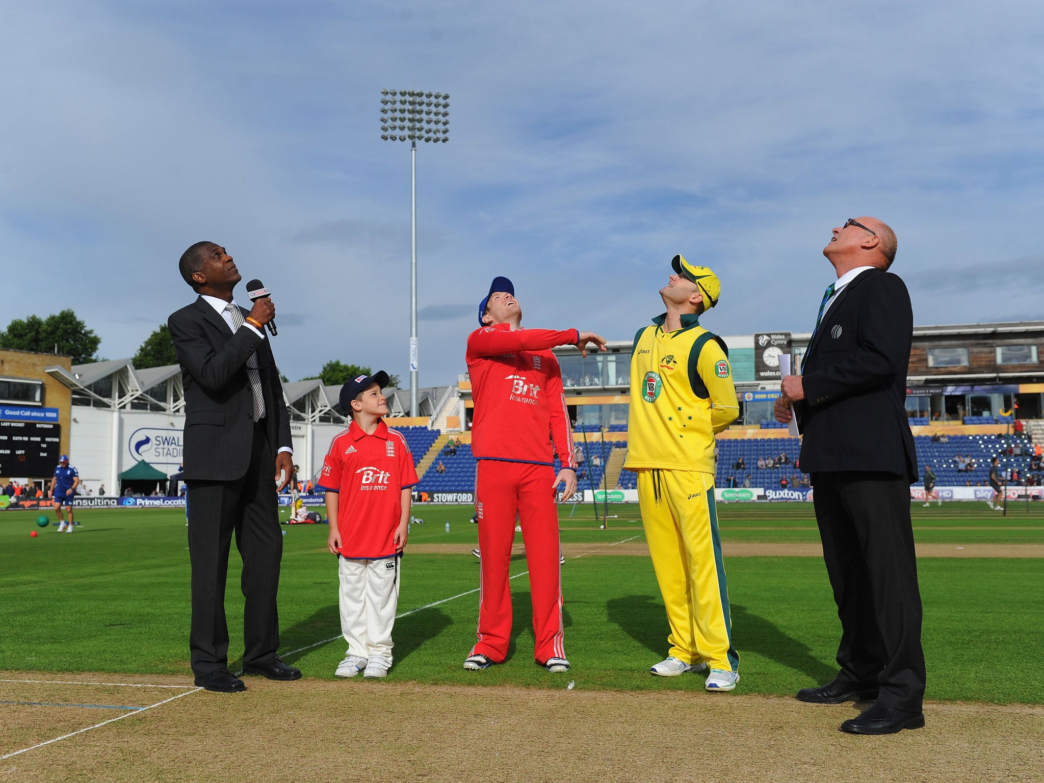 England captain Eoin Morgan tosses the coin watched by Australia captain Michael Clarke