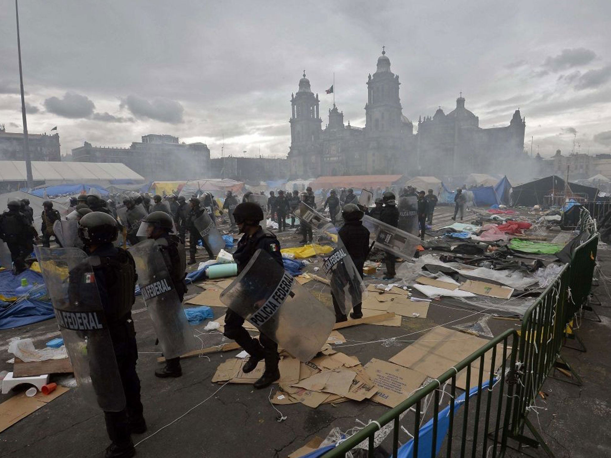 Mexican Federal Police are pictured in the surroundings of Mexico City's Zocalo square during clashes with teachers protesting against an education reform on 13 September as clashes continued today