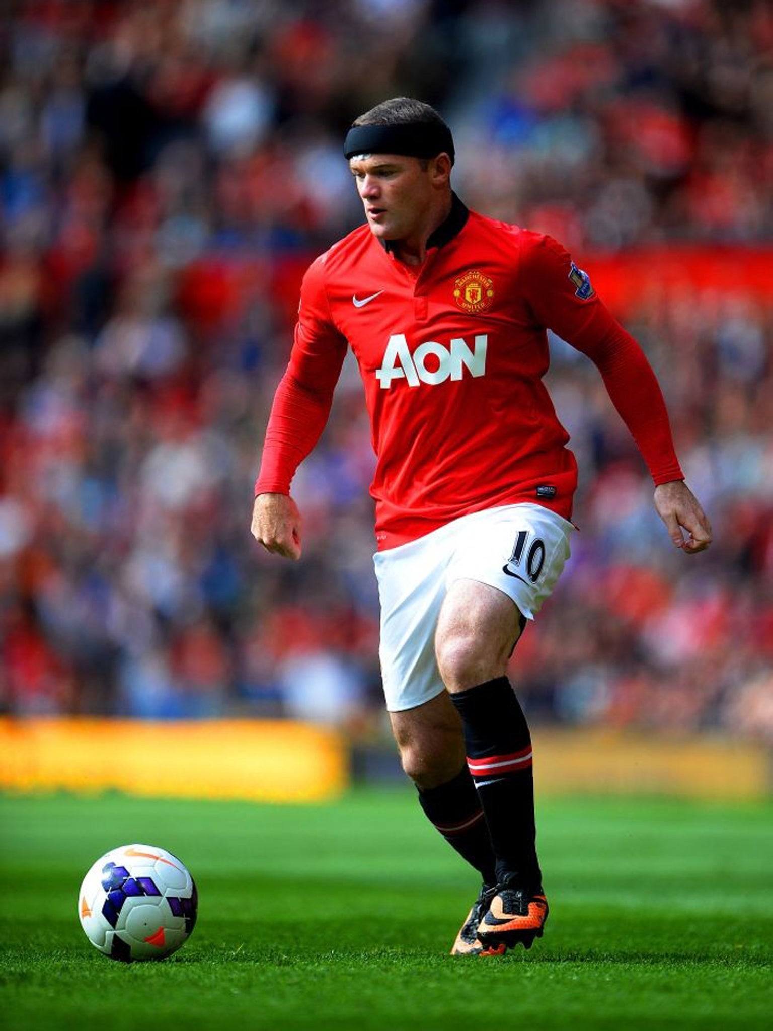 Rooney wears a head protector after head injury three weeks ago