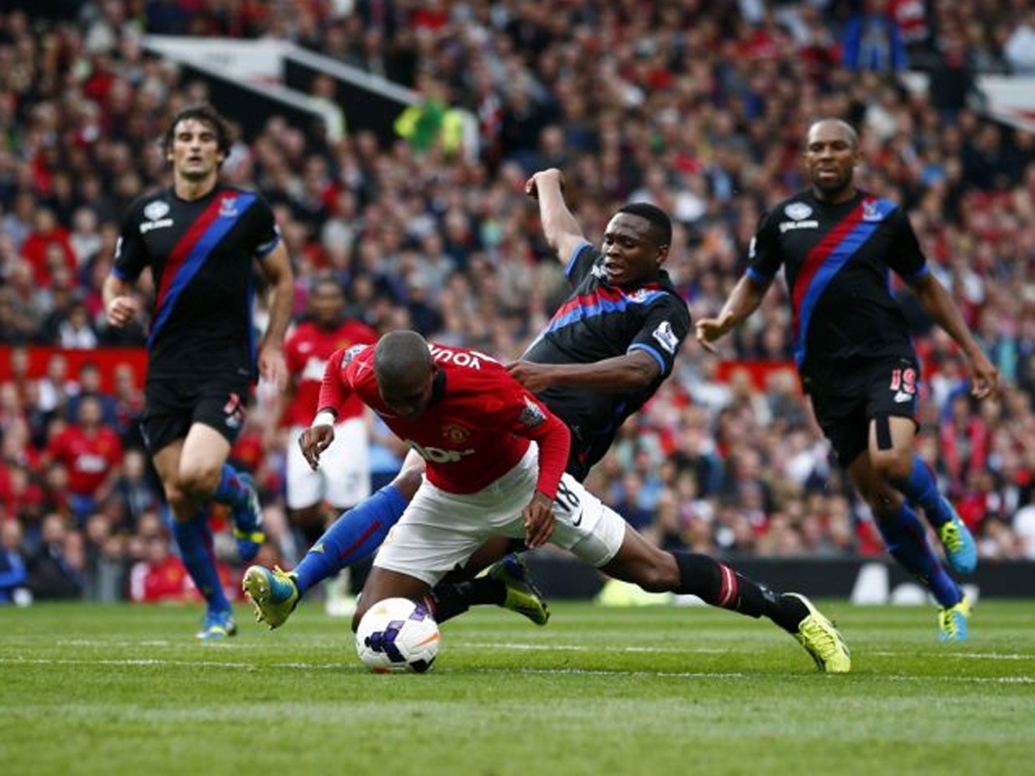 All fall down: Ashley Young tumbles easily at Old Trafford under a challenge from Kagisho Dikgacoi, earning a penalty for Manchester United and the Crystal Palace player’s dismissal for two yellow cards