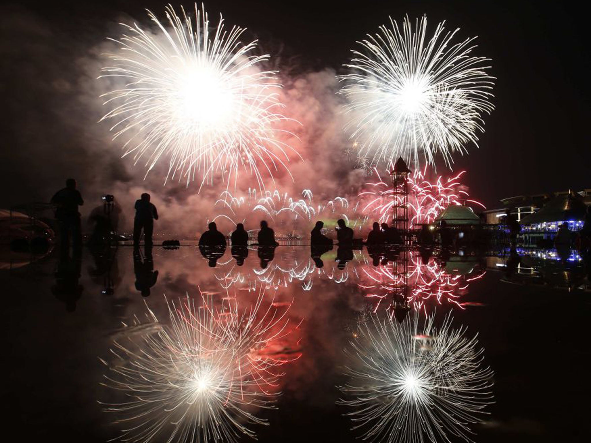 15 September 2013: People watch a fireworks display by team USA over the sky during the Putrajaya International Fireworks Competition outside Kuala Lumpur (Bazuki Muhammad/Reuters)