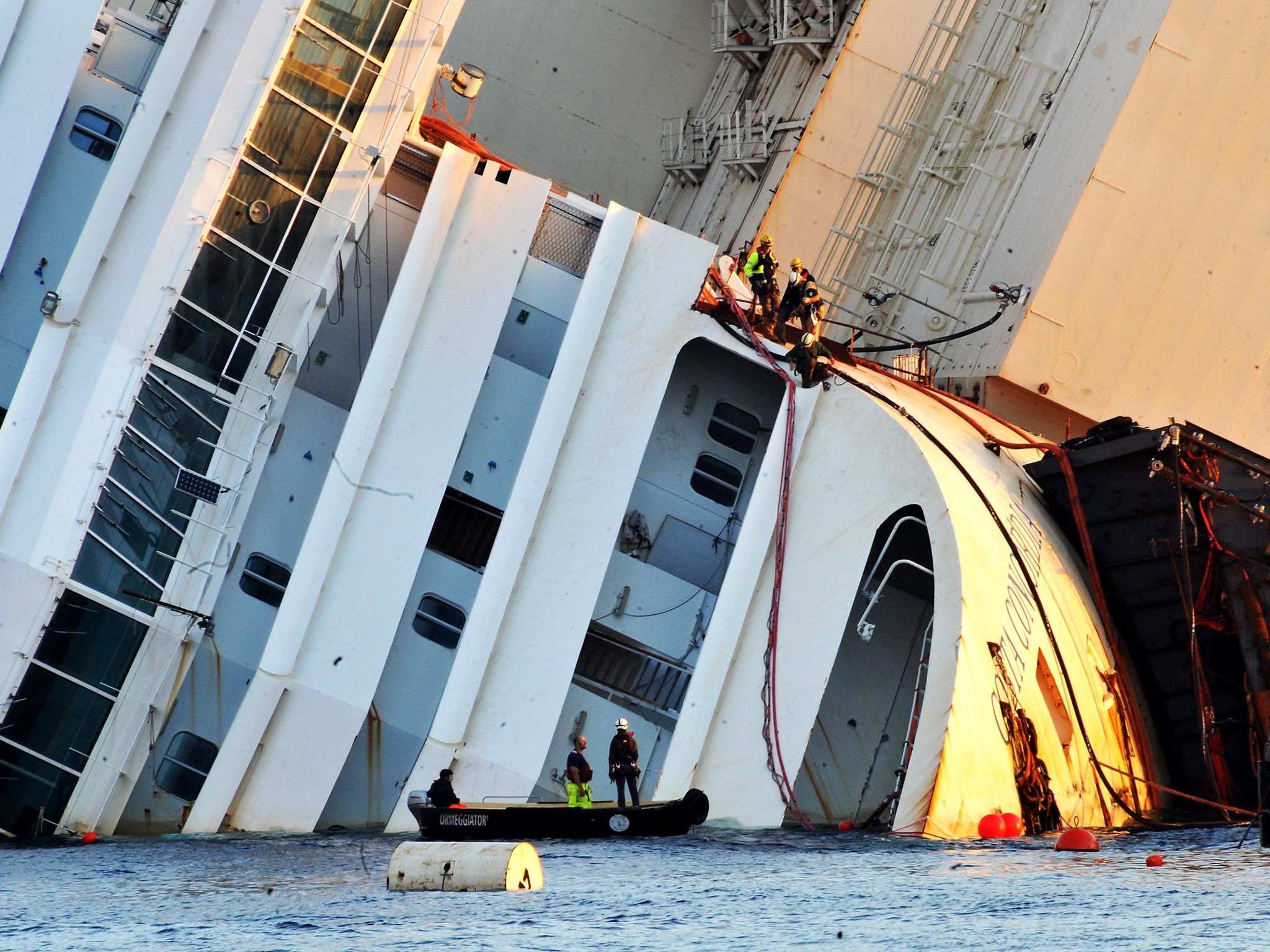 16 September 2013: Titan and Micoperi workers are seen on the stricken Costa Concordia in Isola del Giglio, Italy