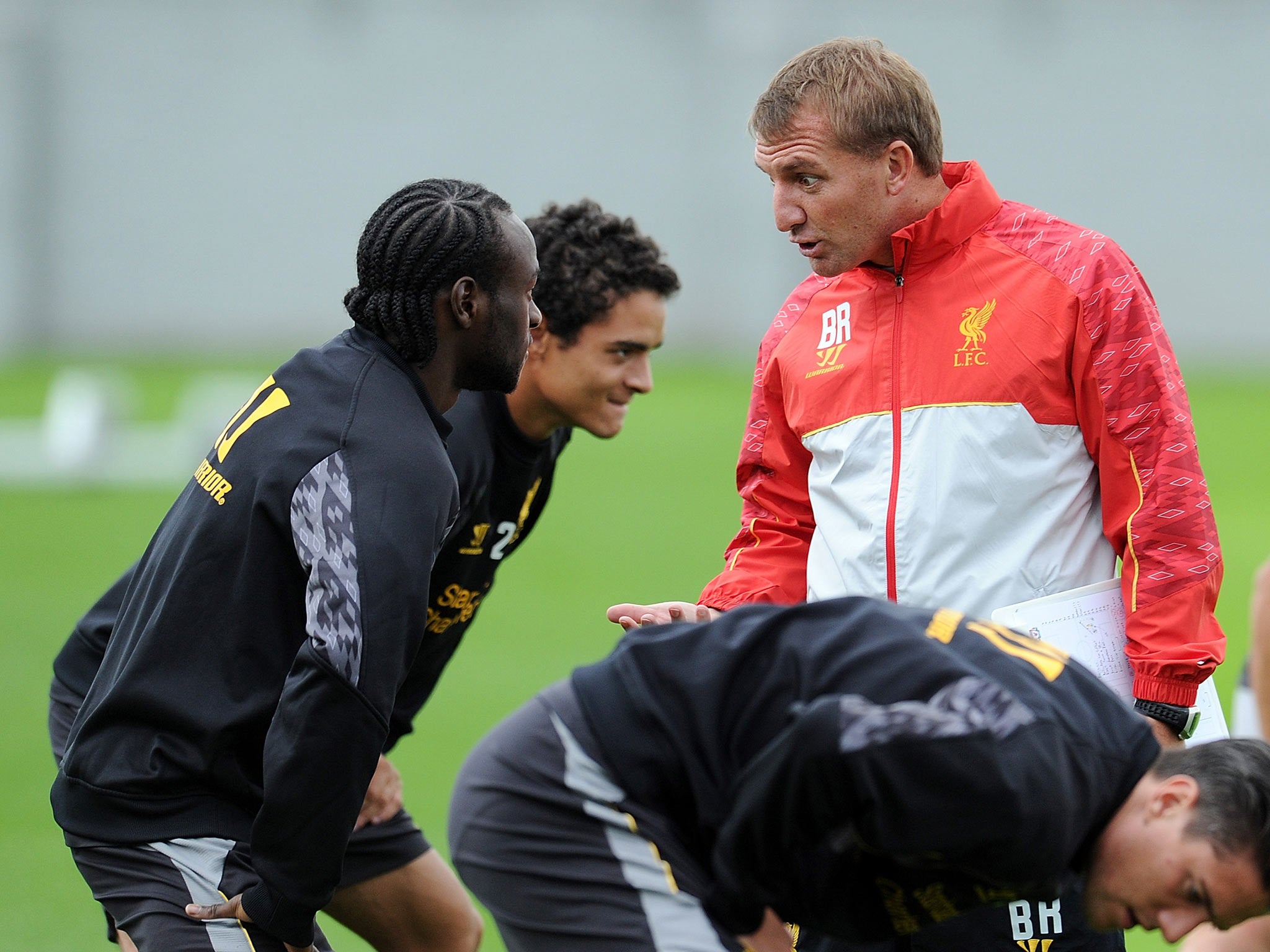 Brendan Rodgers manager of Liverpool talks with Victor Moses