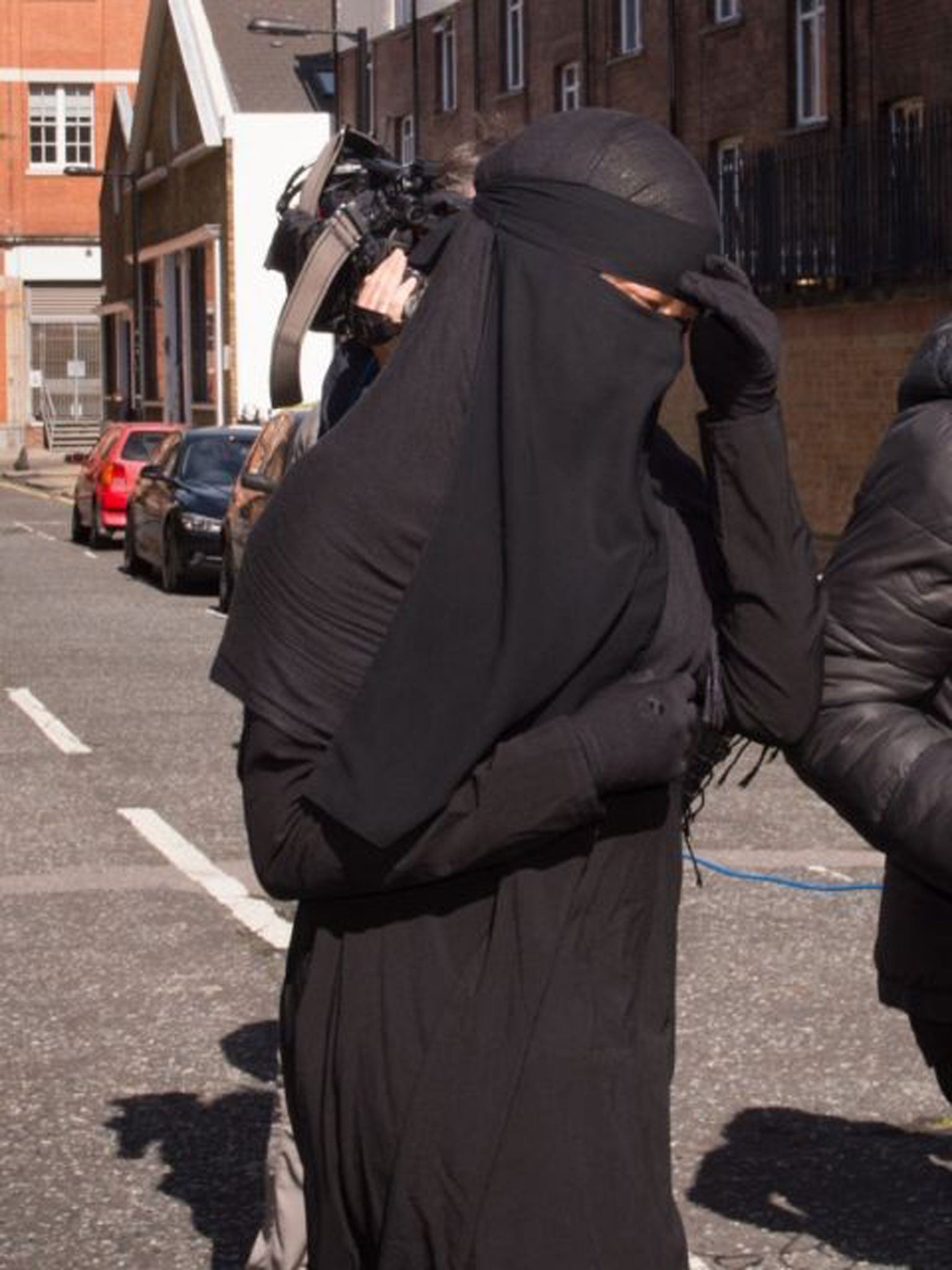 A Muslim woman, who cannot be named for legal reasons, arrives at Blackfriars Crown Court in London where a judge has ruled that she will be allowed to stand trial while wearing a full-face veil but must remove it while giving evidence