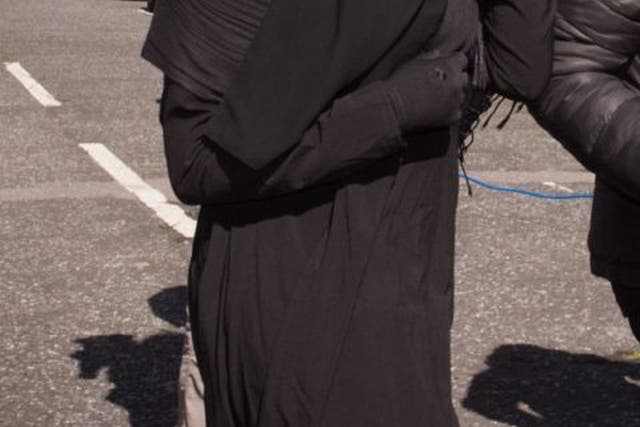 A Muslim woman, who cannot be named for legal reasons, arrives at Blackfriars Crown Court in London where a judge has ruled that she will be allowed to stand trial while wearing a full-face veil but must remove it while giving evidence