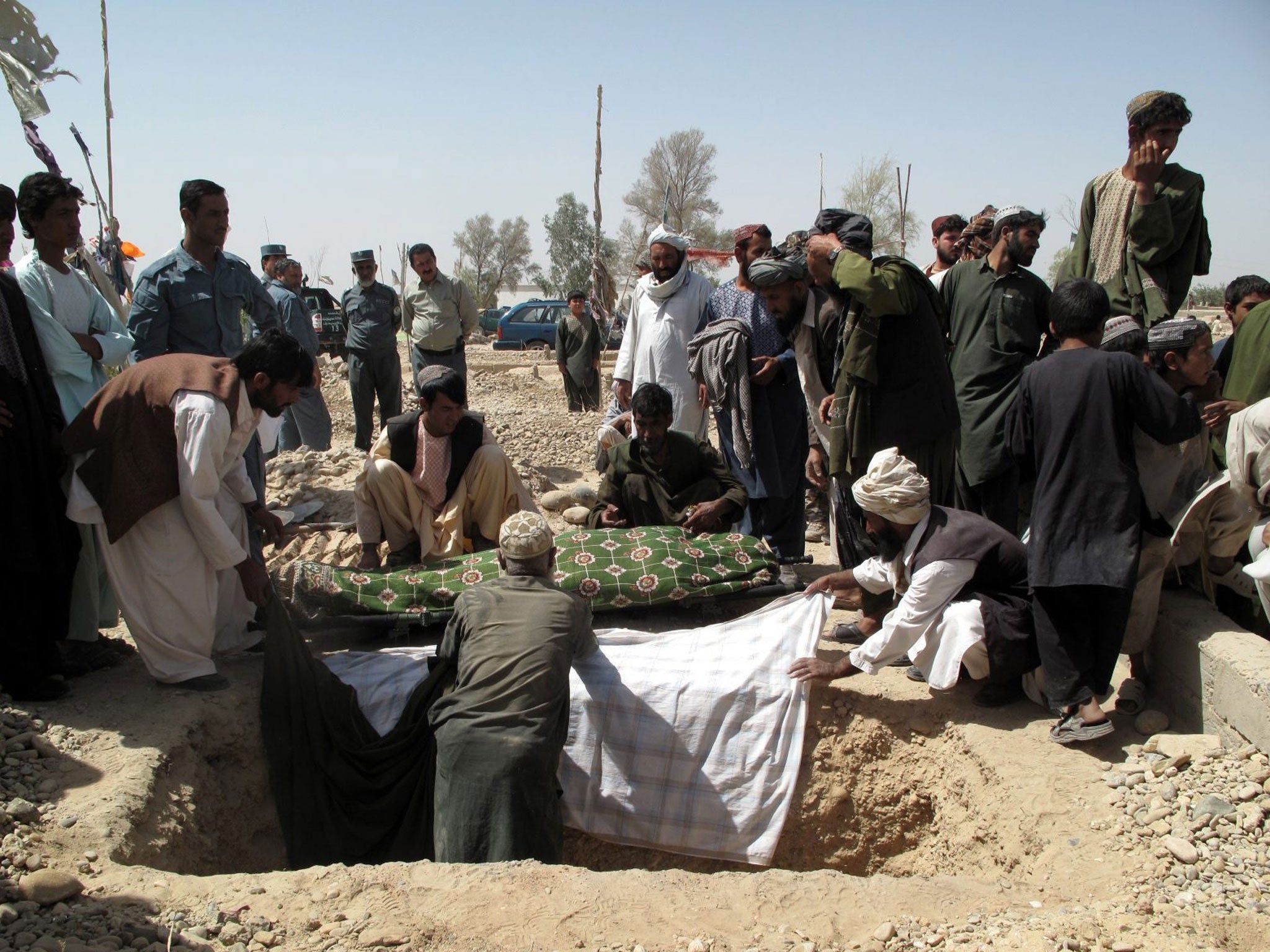 Relatives bury the body of Lieutenant Negar, a senior Afghan female police officer in Helmand, Afghanistan