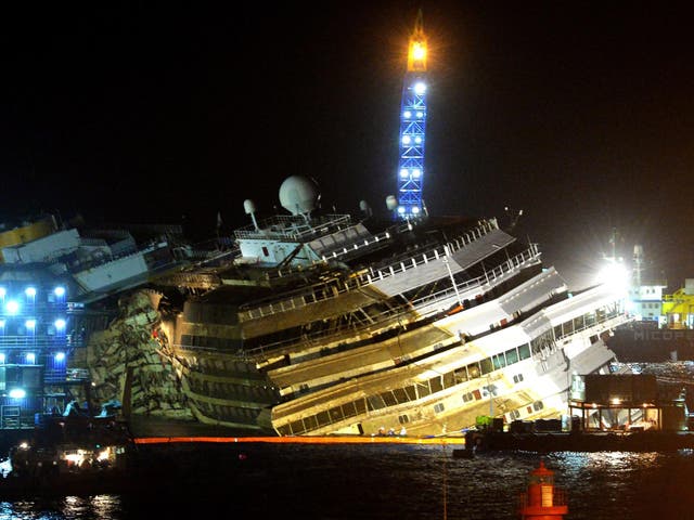 17 September 2013: The wreckage of Italy's Costa Concordia cruise ship which begins to emerge from water near the harbour of Giglio Porto. 
