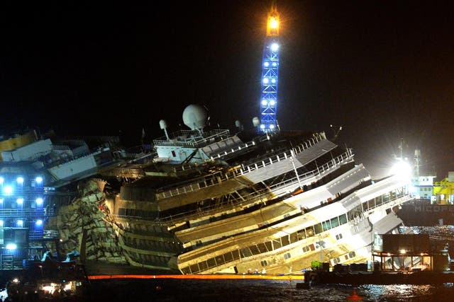 17 September 2013: The wreckage of Italy's Costa Concordia cruise ship which begins to emerge from water near the harbour of Giglio Porto. 
