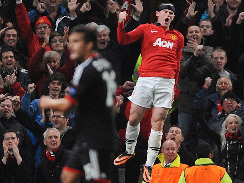 Wayne Rooney jumps with delight after scoring his second goal
