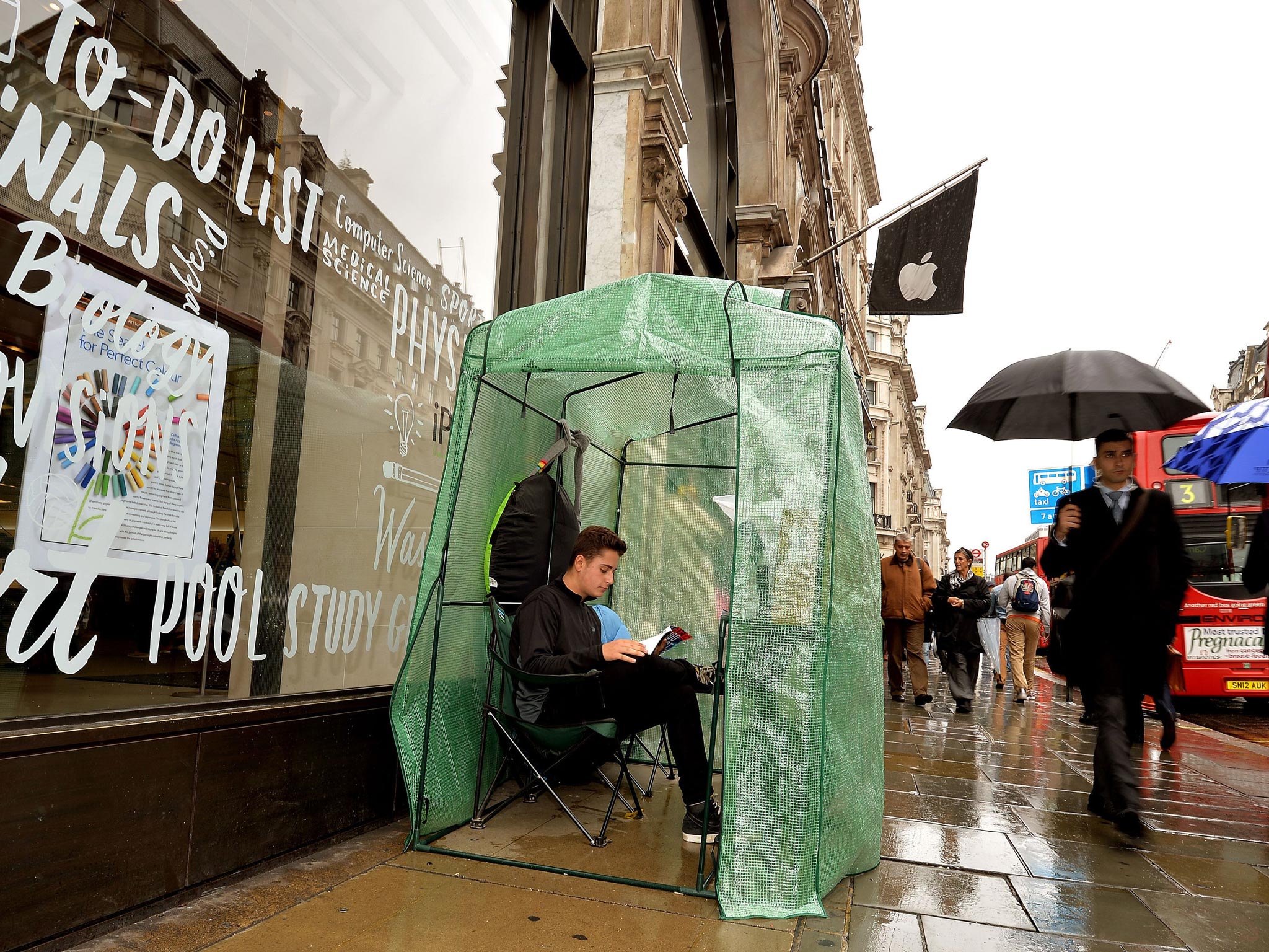 Noah Green aged 17, from London, sits in his plastic greenhouse which is the only shelter for himself as he waits to buy the new iPhone in Regent Street central London, which goes on sale in the UK this coming Friday