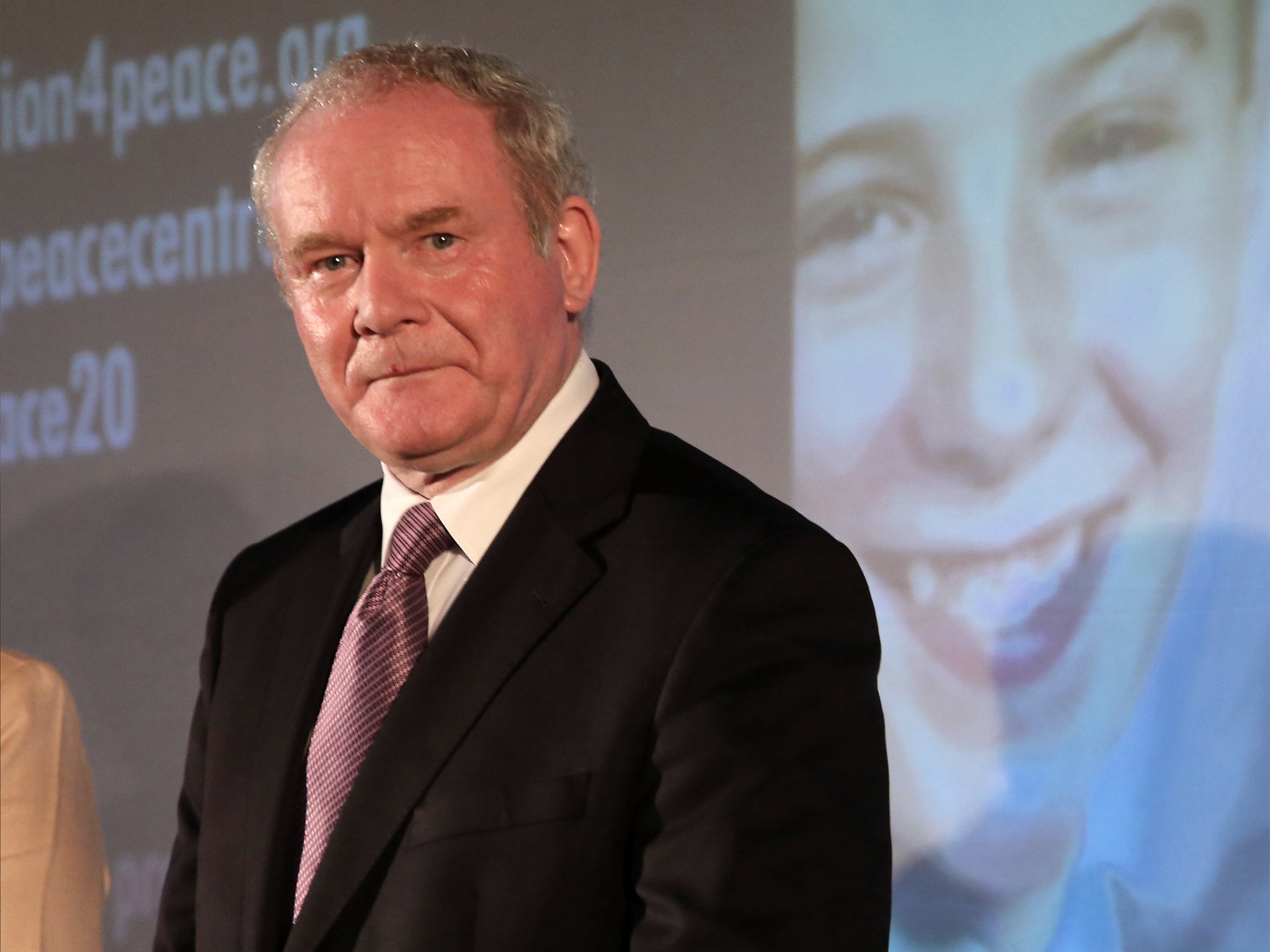 Martin McGuinness stands in front of a projected image of bombing victim Tim Parry, during the press conference in Warrington