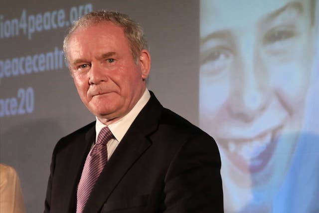 Martin McGuinness stands in front of a projected image of bombing victim Tim Parry, during the press conference in Warrington