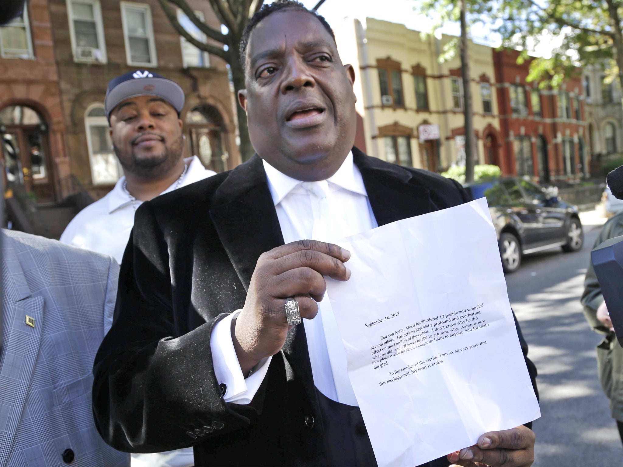 Bishop Gerald Seabrooks holds up the statement made by Cathleen Alexis