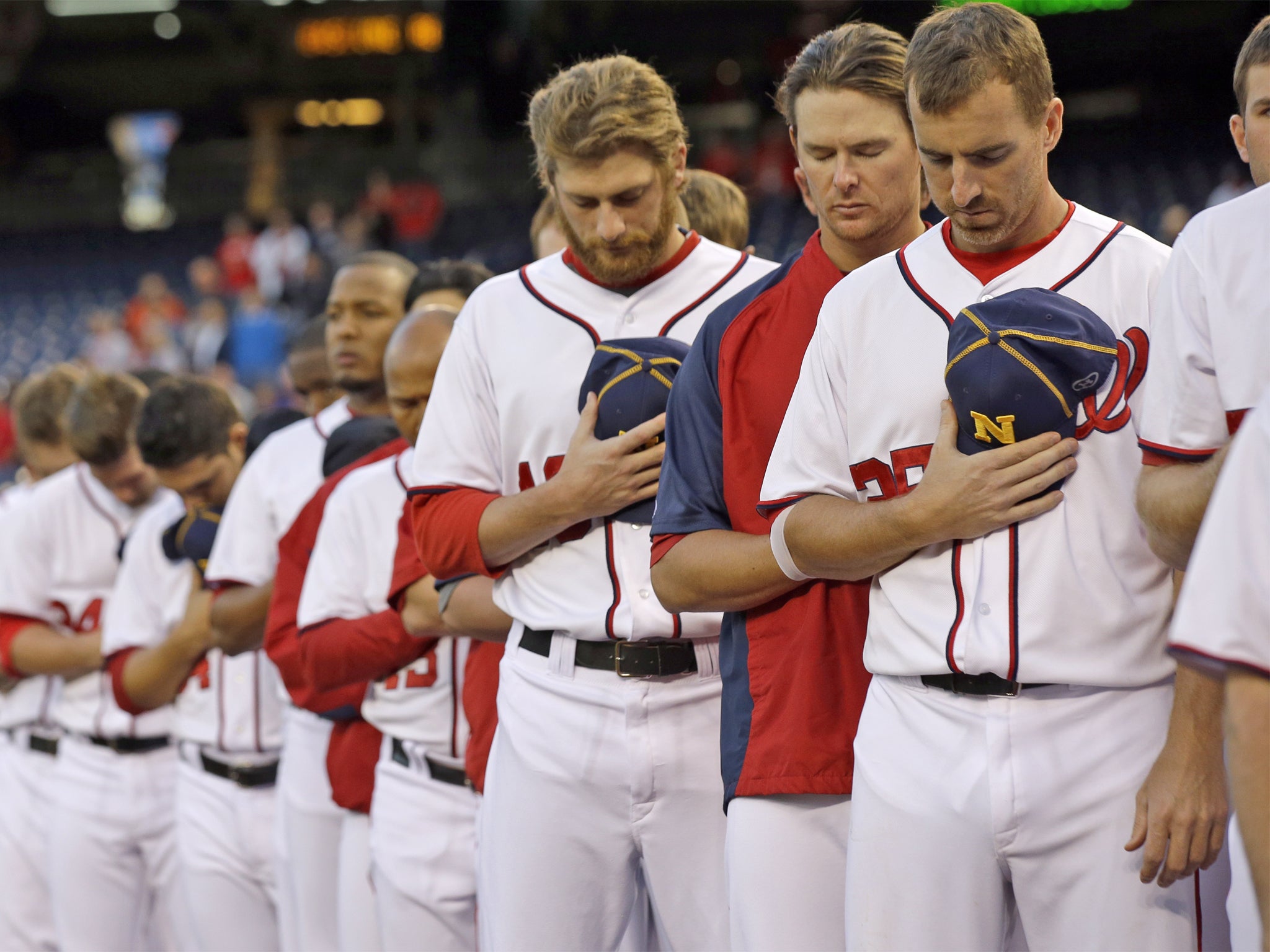 The Washington Nationals observe a moment of silence before their game on Tuesday night