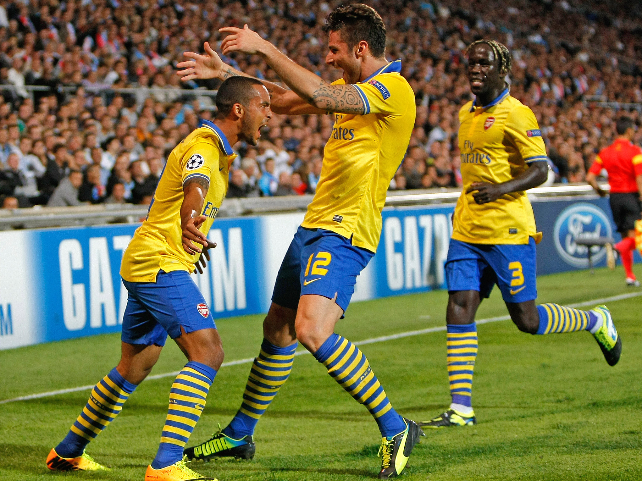 Theo Walcott is joined by his teammates to celebrate the opening goal
