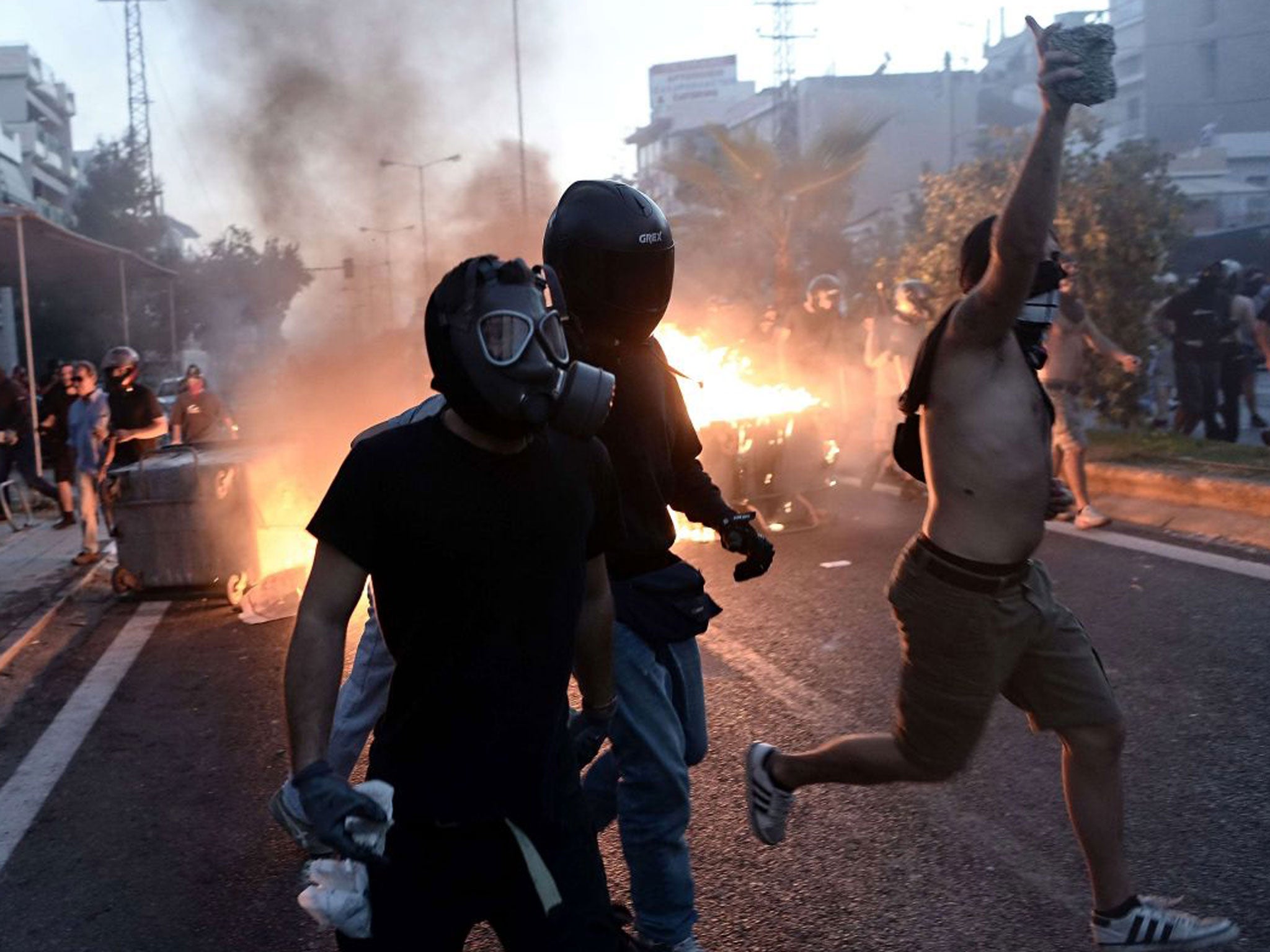 Anti-fascist demonstrators clash with riot police in an Athens suburb following the murder of left-wing musician Pavlos Fysass