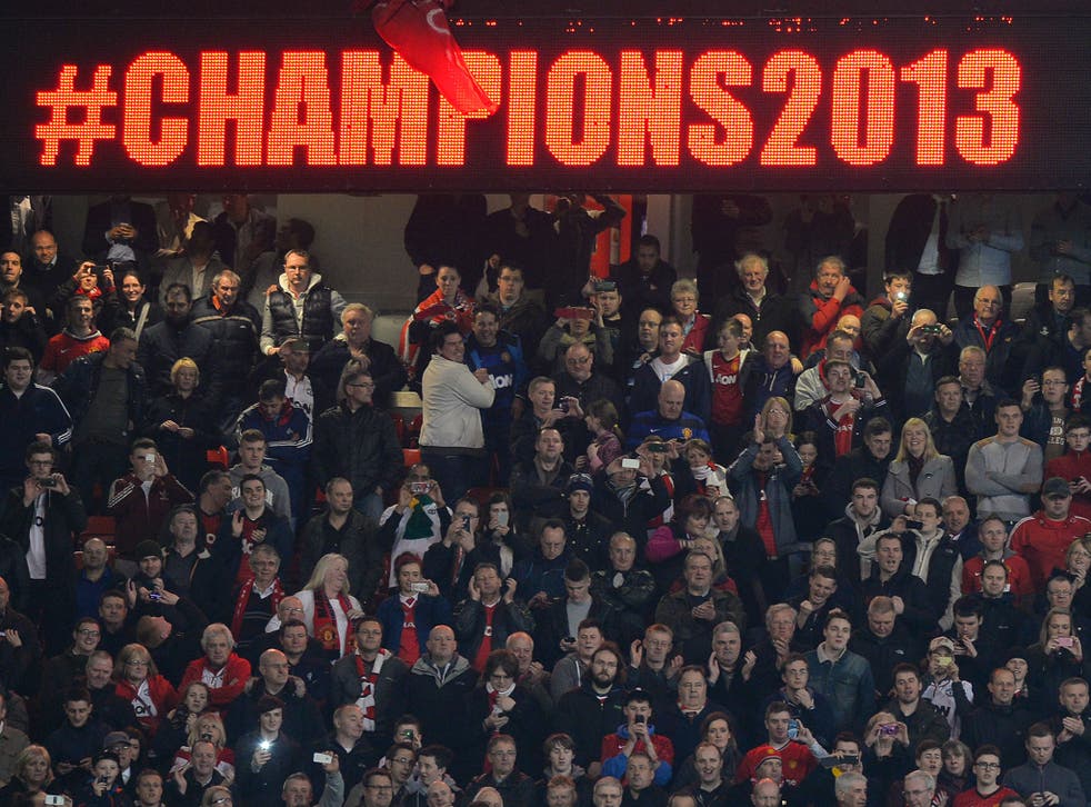 The Manchester United fans celebrate at Old Trafford