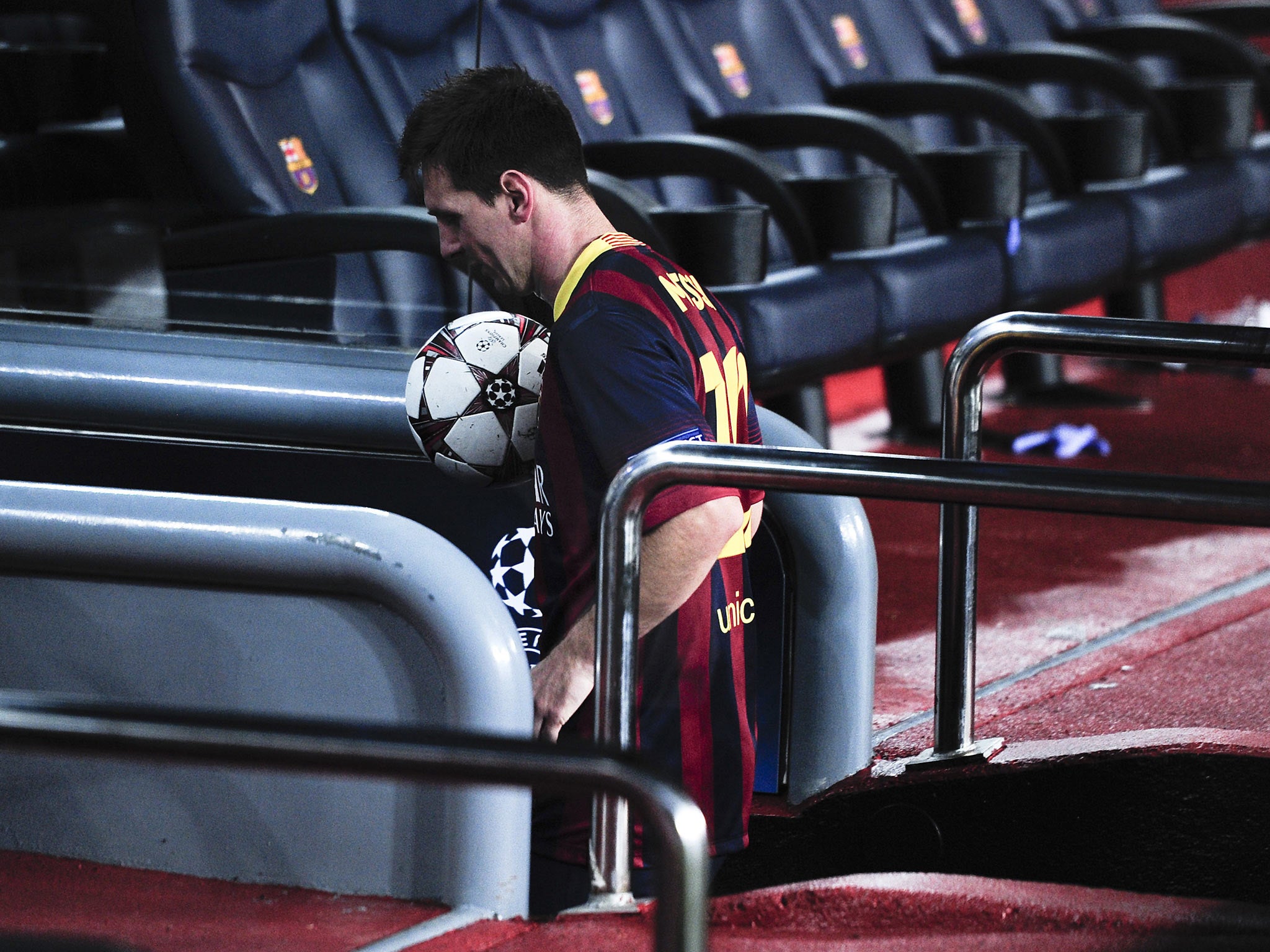 Lionel Messi leaves with the match ball after his hat-trick against Ajax