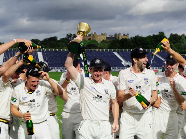 Durham captain Paul Collingwood (c) and team celebrate with the trophy after winning the LV County Championship Division One title