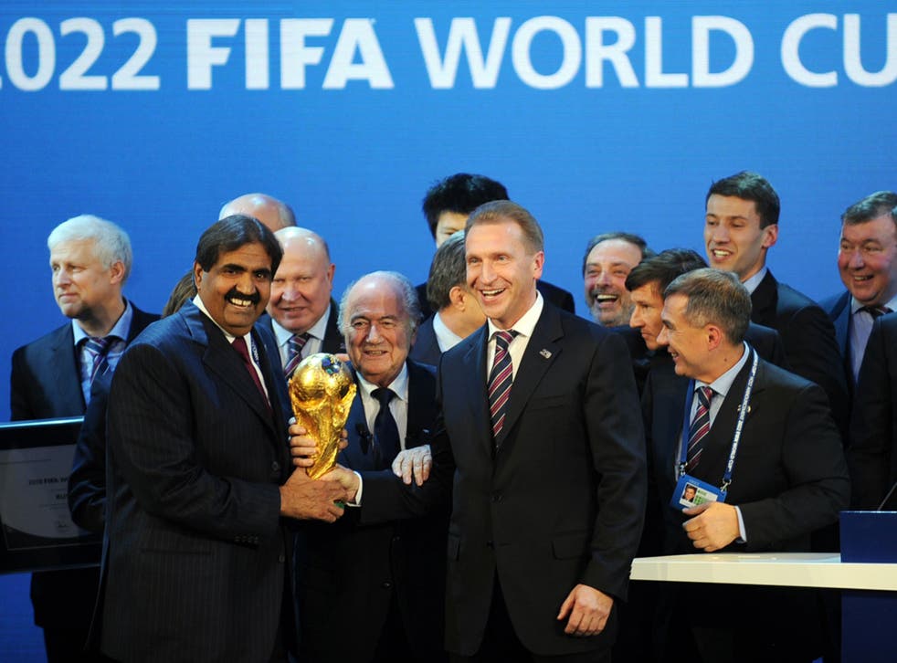 Emir of the State of Qatar Sheikh Hamad bin Khalifa Al-Thani (left) and Fifa President Sepp Blatter pose with the World Cup after the Qatar announcement in 2010