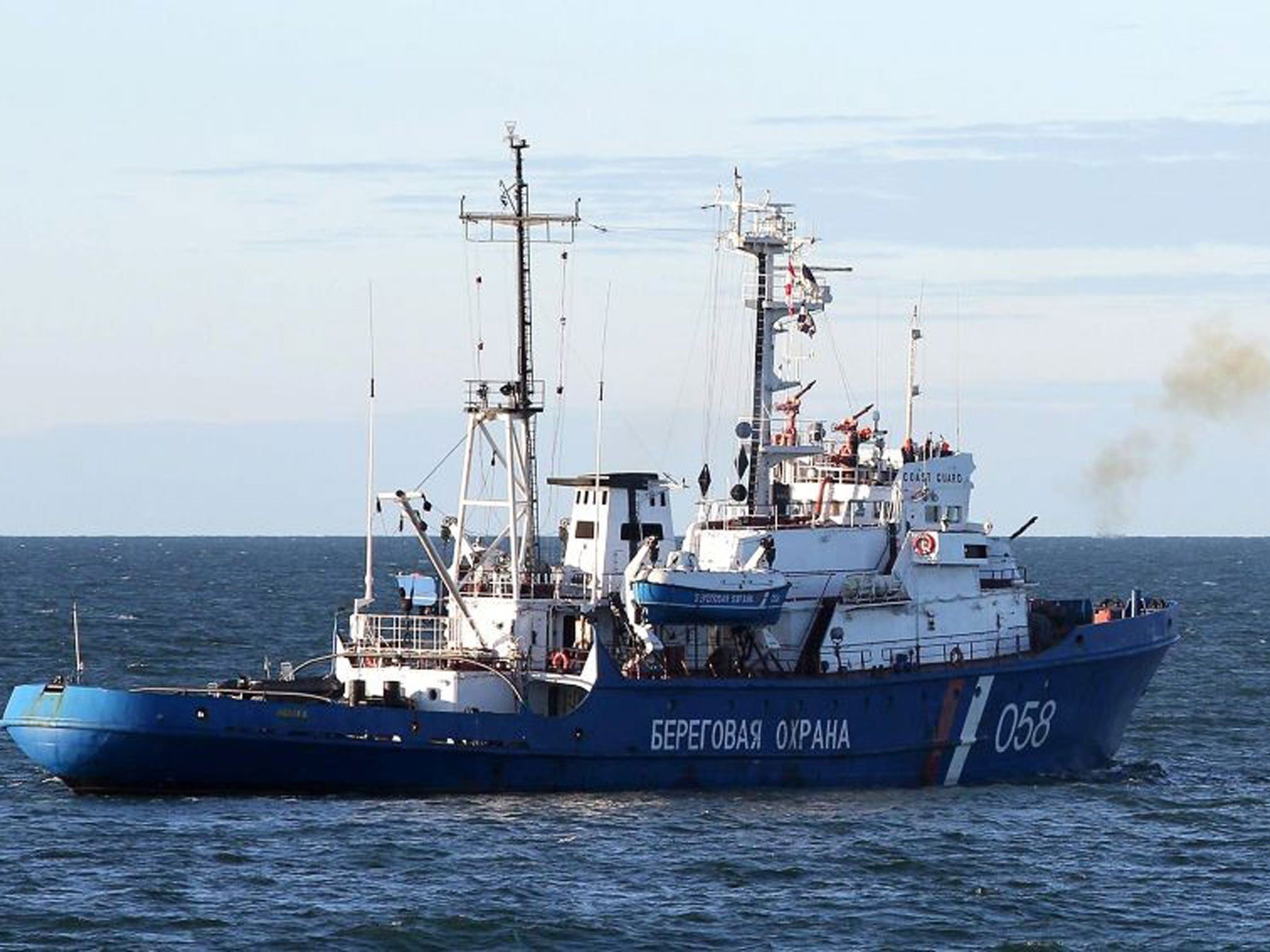 A Russian Coast Guard ship fires a warning shot towards activists