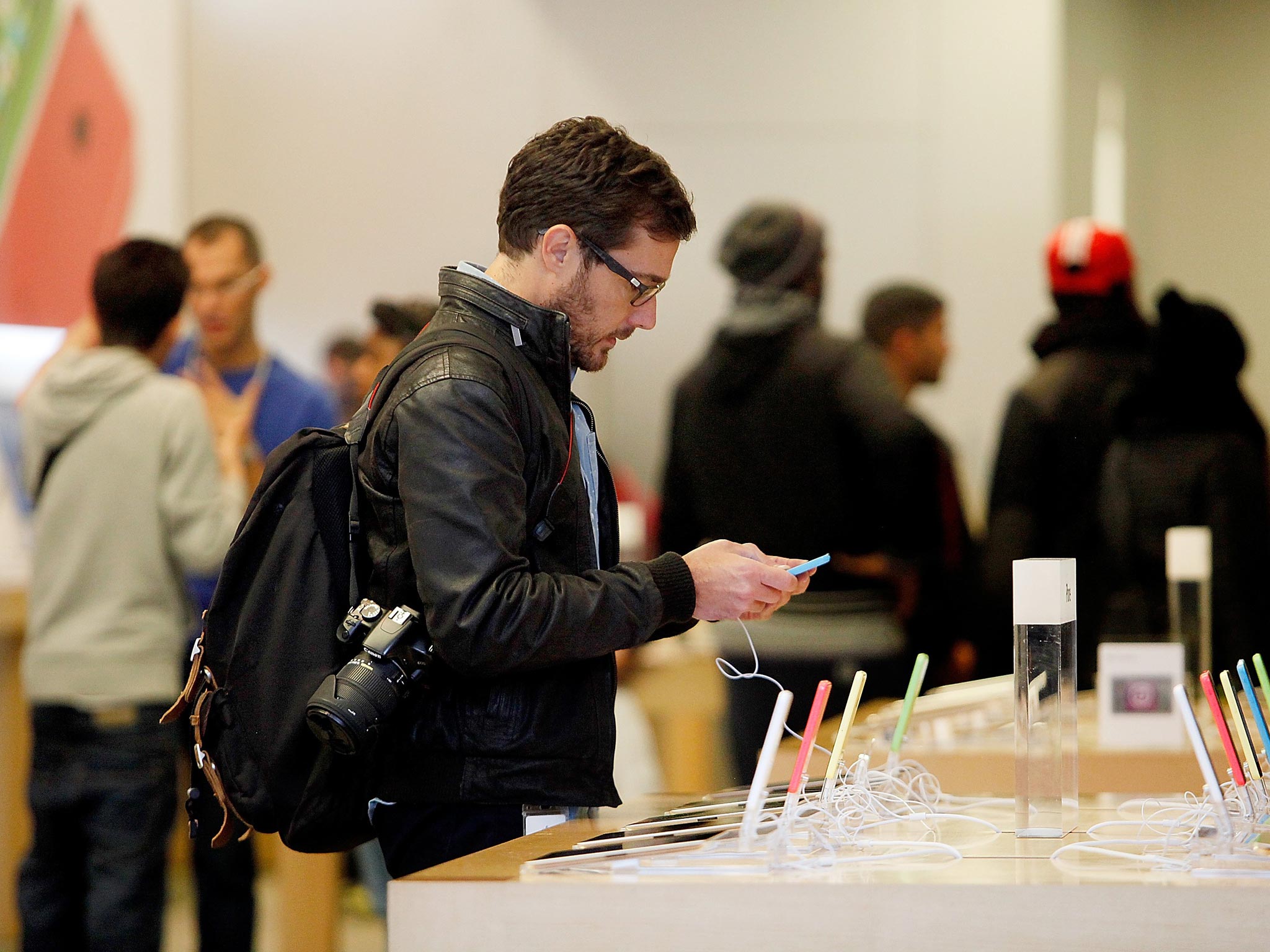 A customer examines the new iPhone 5S as they go on sale for the first time, in the Apple store on Regent Street