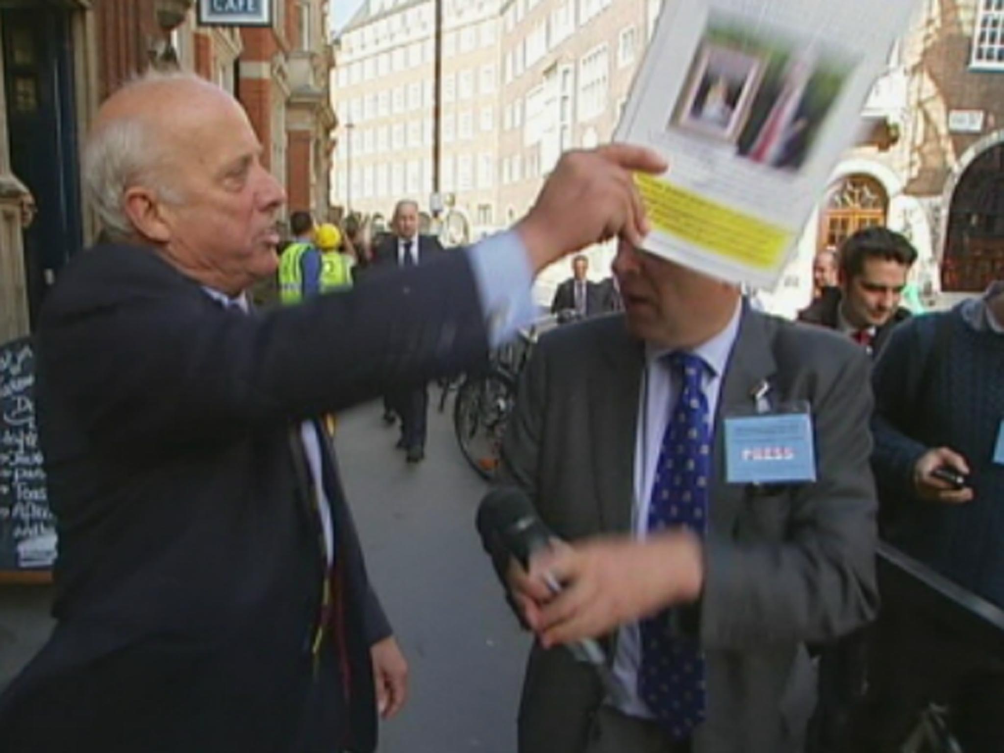 Bloom branded Crick 'disgraceful' before hitting him over the head with the brochure and throwing it to the floor