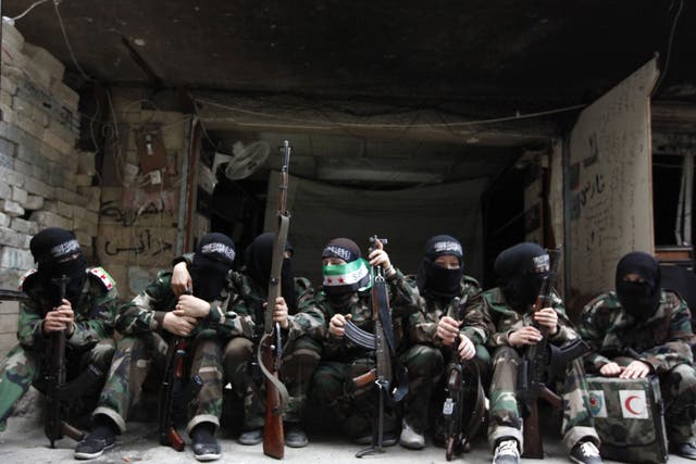 Female members of the 'Mother Aisha' battalion – an all female unit of the Syrian rebels – sit together in Aleppo’s Salaheddine district
