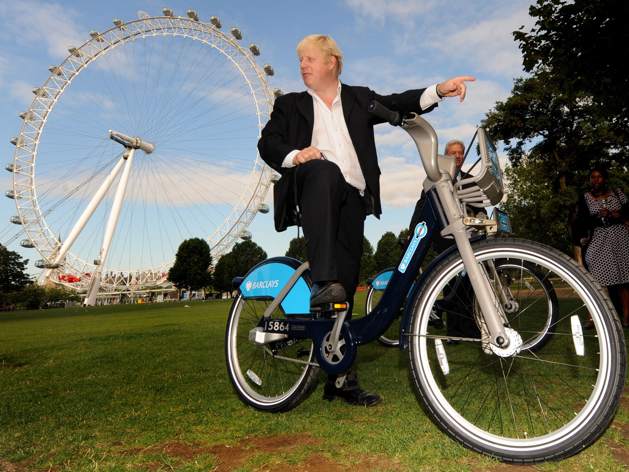 Mayor of London, Boris Johnson, poses for photographs during the launch of the London Cycle Hire bicycle scheme in central London, on July 30, 2010.