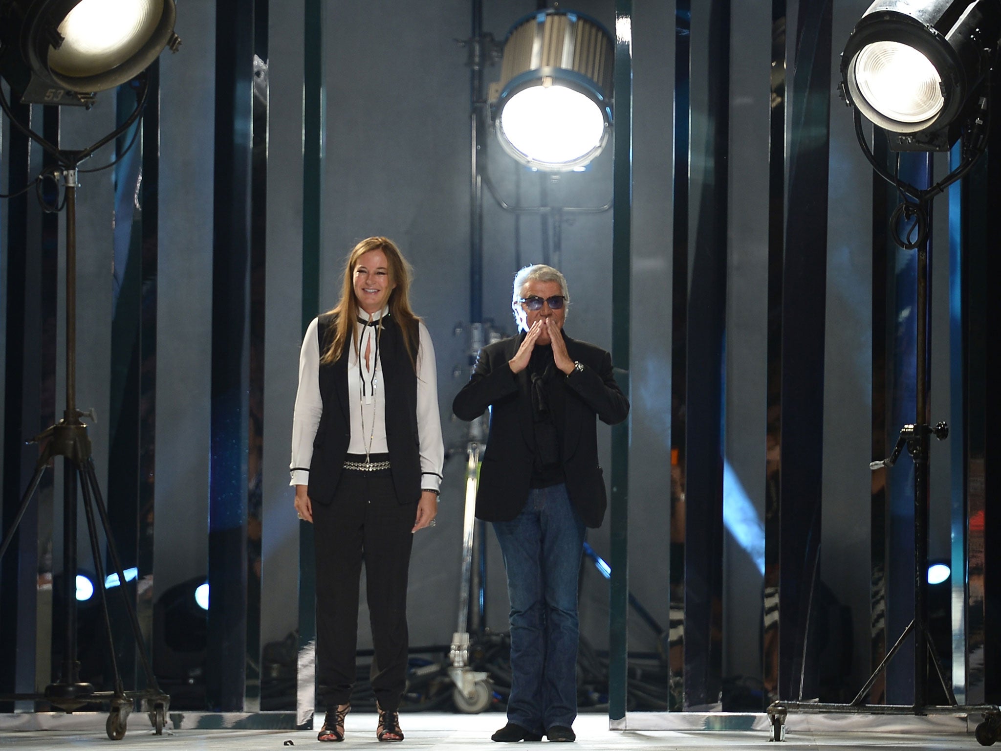 MILAN, SEPTEMBER 21: Italian designers Roberto Cavalli and wife Eva Düringer acknowledge the applause of the audience after their show as part of the spring/summer 2014 ready-to-wear collections. GETTY IMAGES